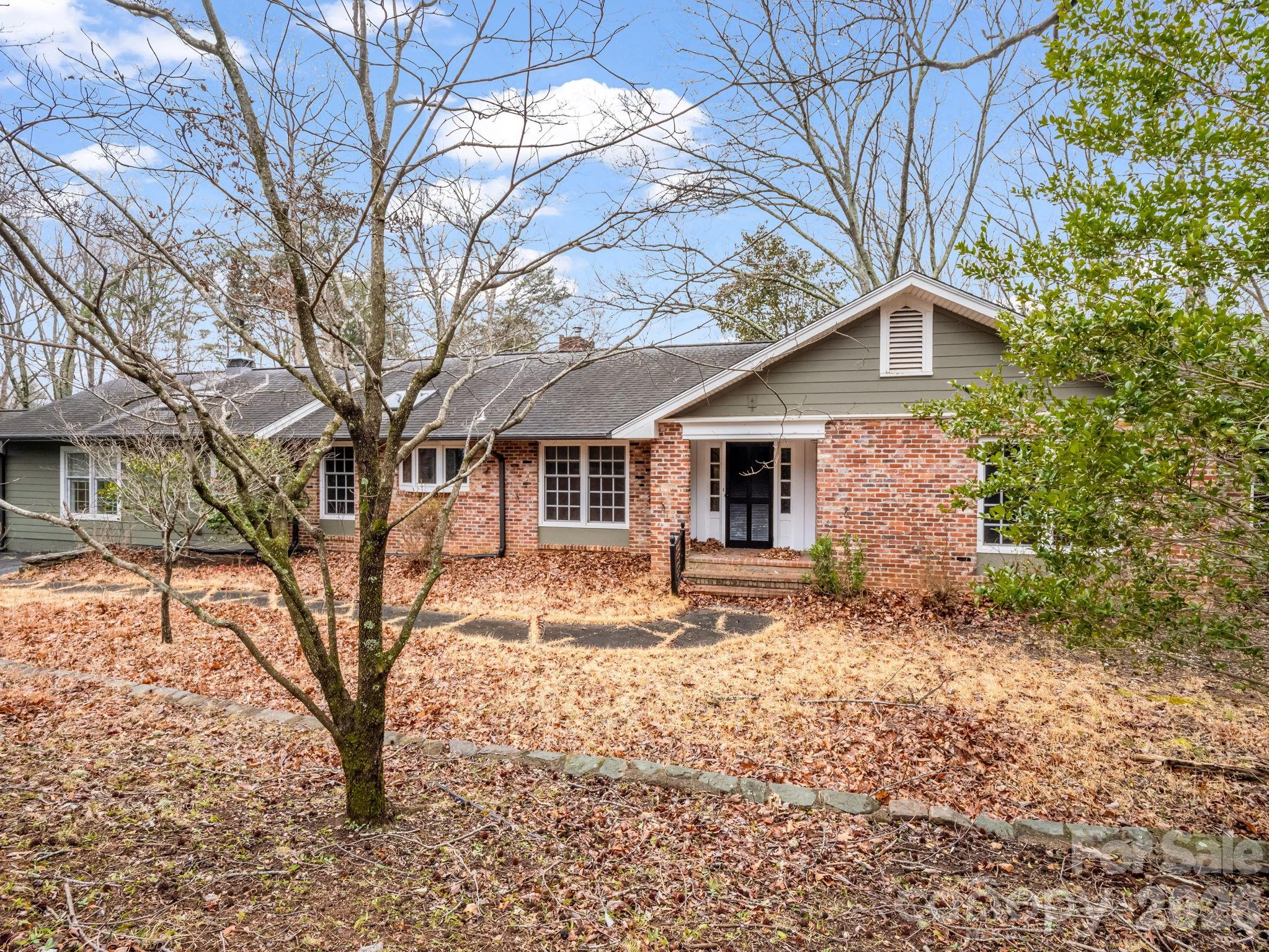 117 Hummingbird Lane Columbus, NC 28722 - Photo 4 of 32 a front view of a house with a yard