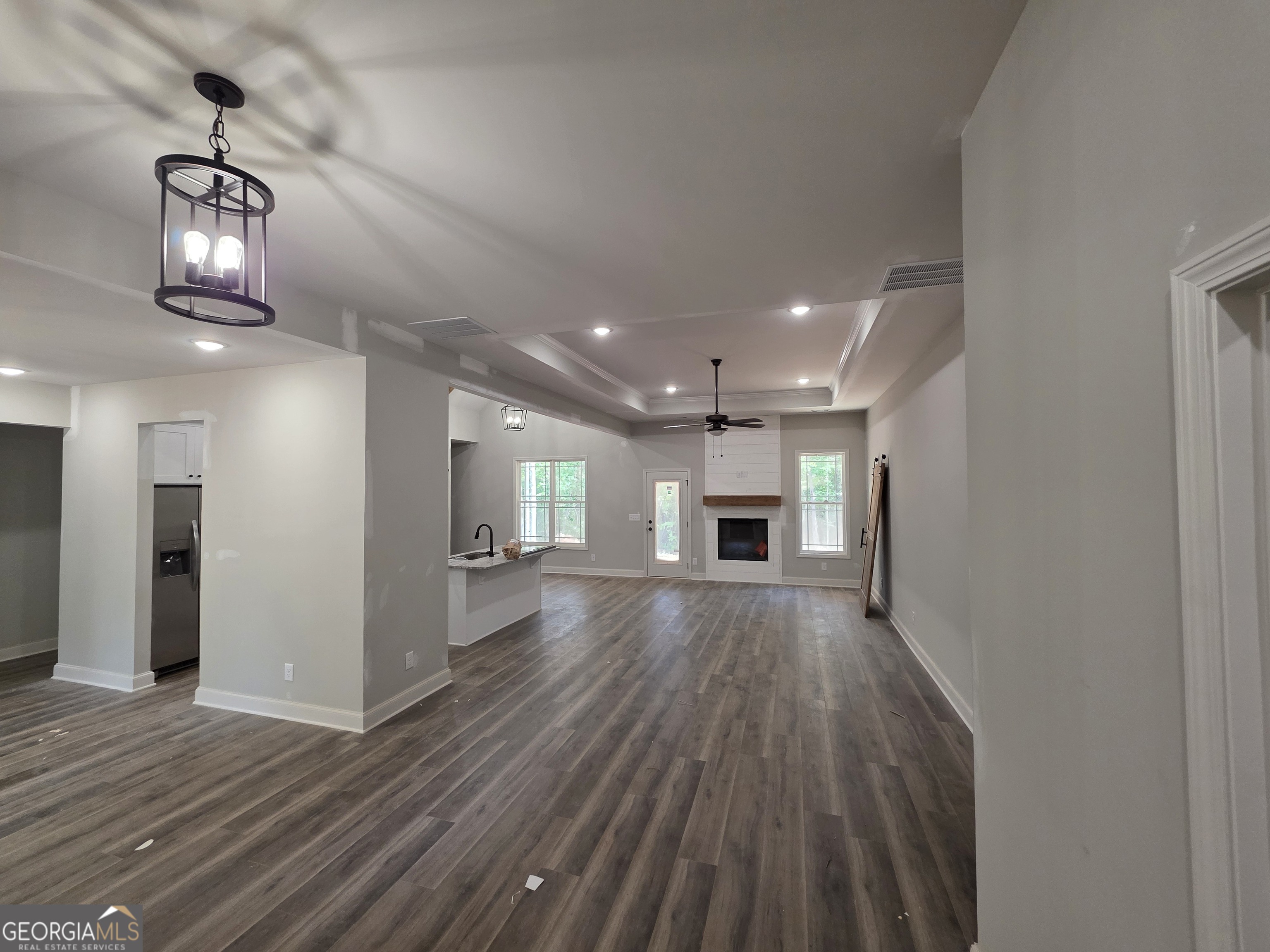 215 Panola Road Jackson, GA 30233 - Photo 3 of 16 an empty room with wooden floor and windows
