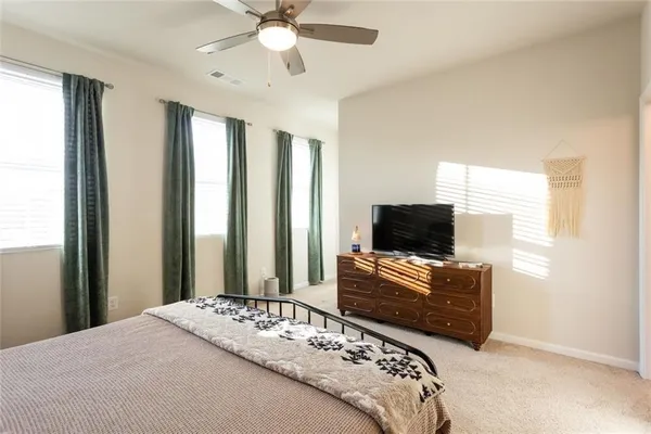 a bedroom with bed and flat screen tv