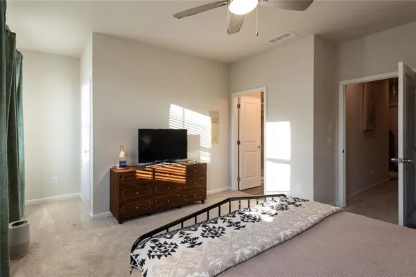 a bedroom with a bed and a flat tv screen
