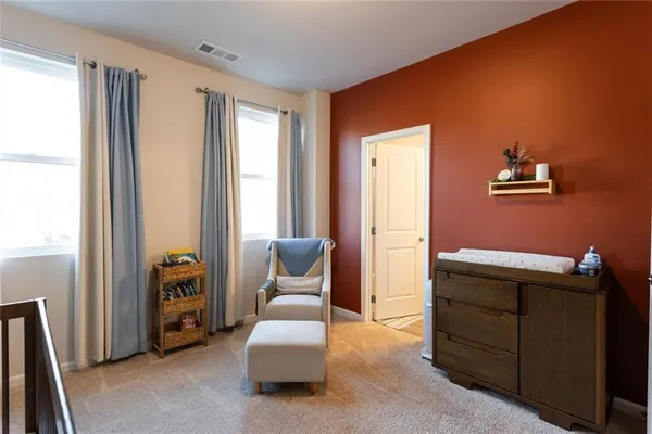 a spacious bedroom with a bed and a couch