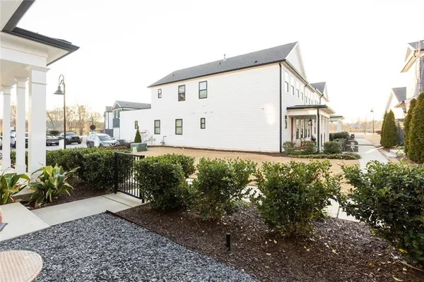 front view of a brick house with a yard