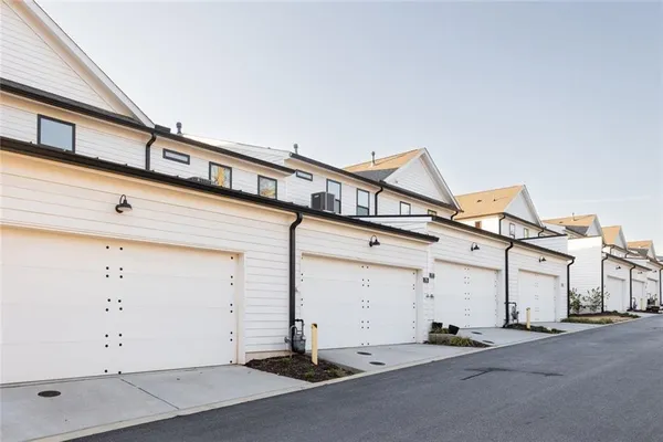 a view of roof deck with chairs and wooden fence