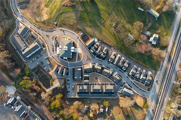 an aerial view of residential houses with outdoor space