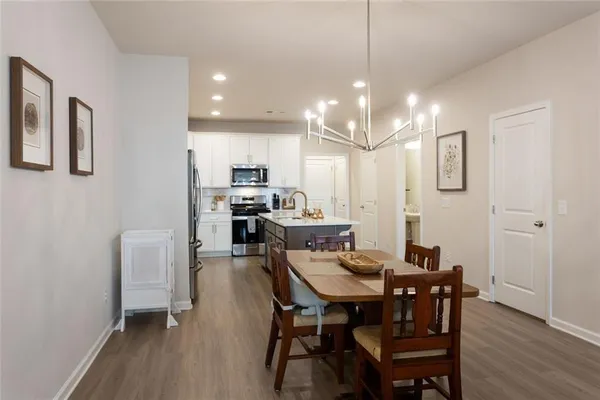 a view of a dining room with furniture and wooden floor