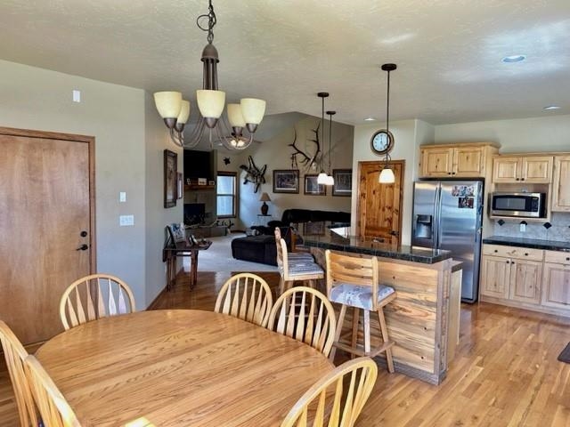 800 Esprit Lane Fruita, CO 81521 - Photo 15 of 38 a view of a dining room and livingroom with furniture wooden floor a chandelier