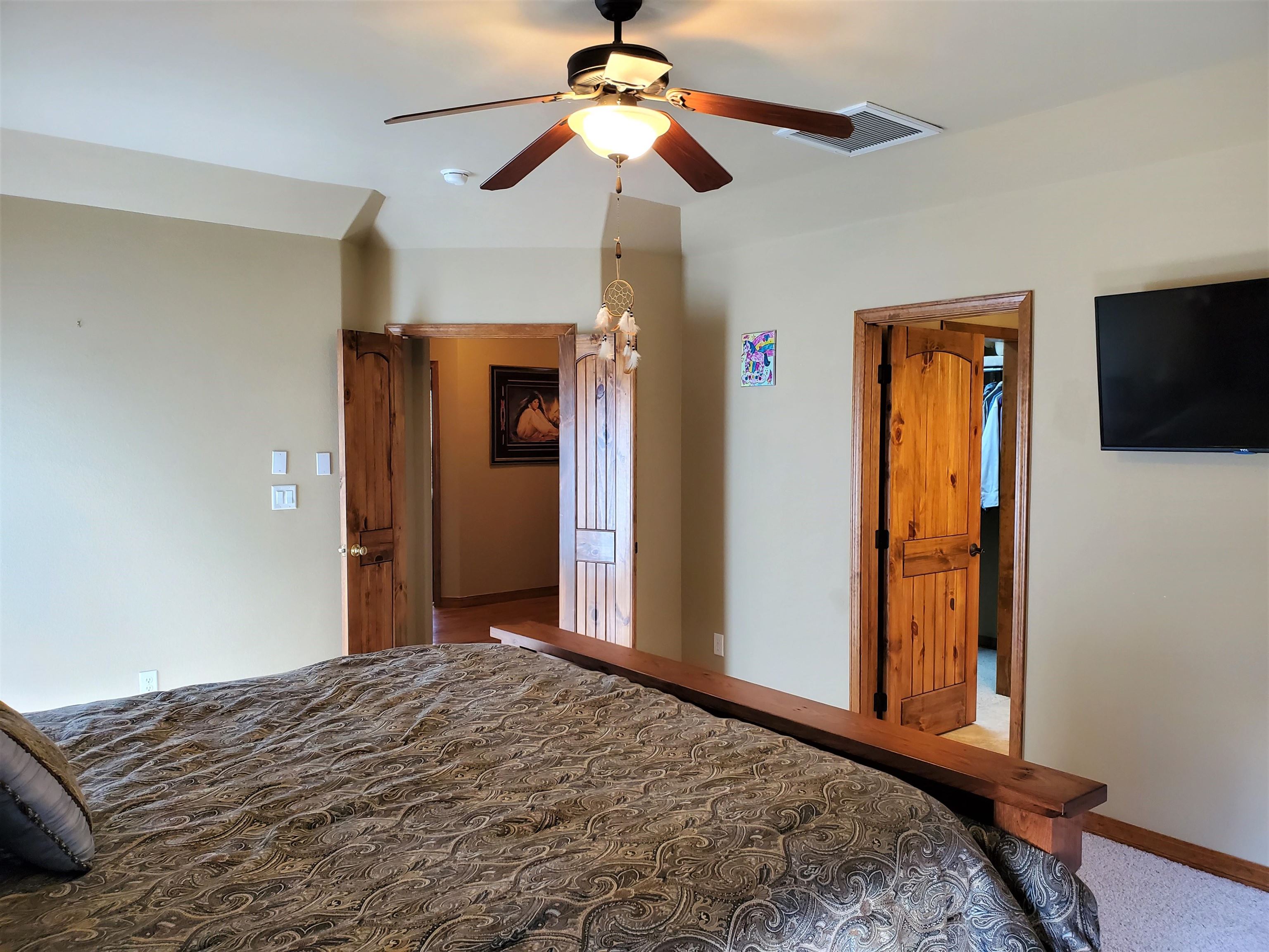 800 Esprit Lane Fruita, CO 81521 - Photo 19 of 38 a bedroom with a bed and a flat screen tv