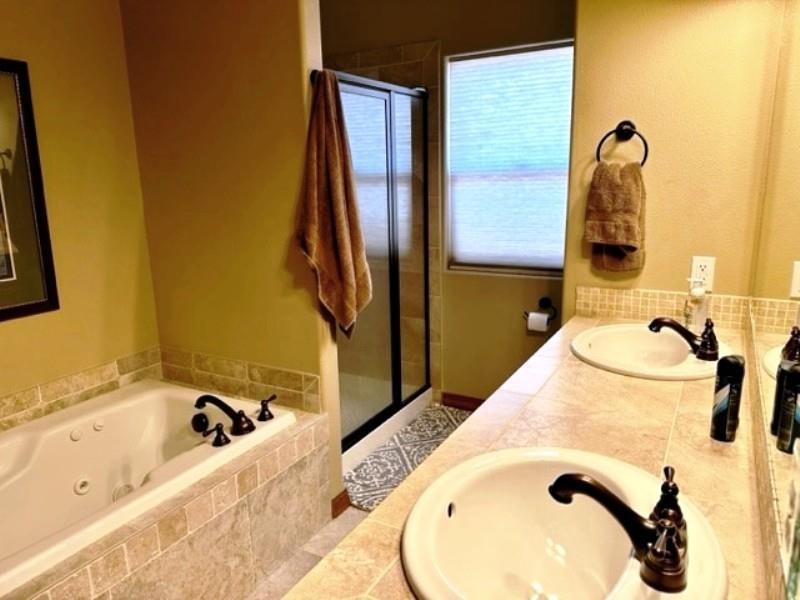 800 Esprit Lane Fruita, CO 81521 - Photo 21 of 38 a bathroom with a tub sink and mirror