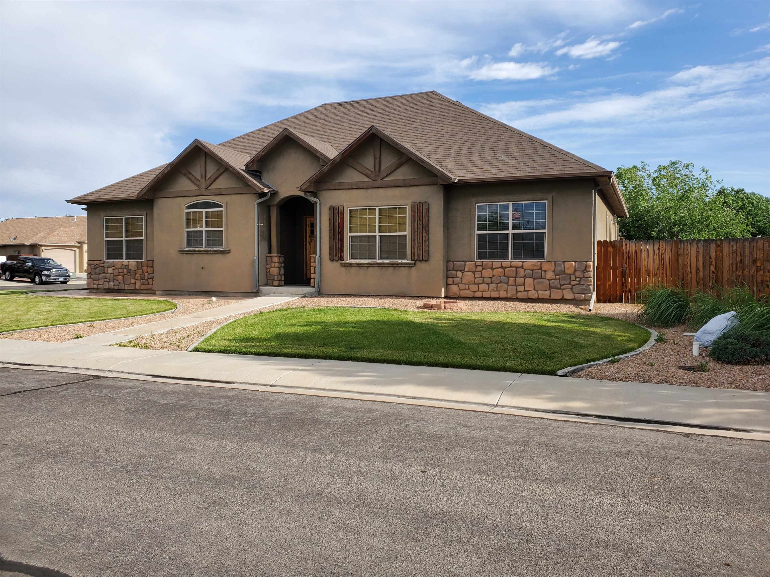 800 Esprit Lane Fruita, CO 81521 - Photo 36 of 38 a front view of a house with a yard and garage