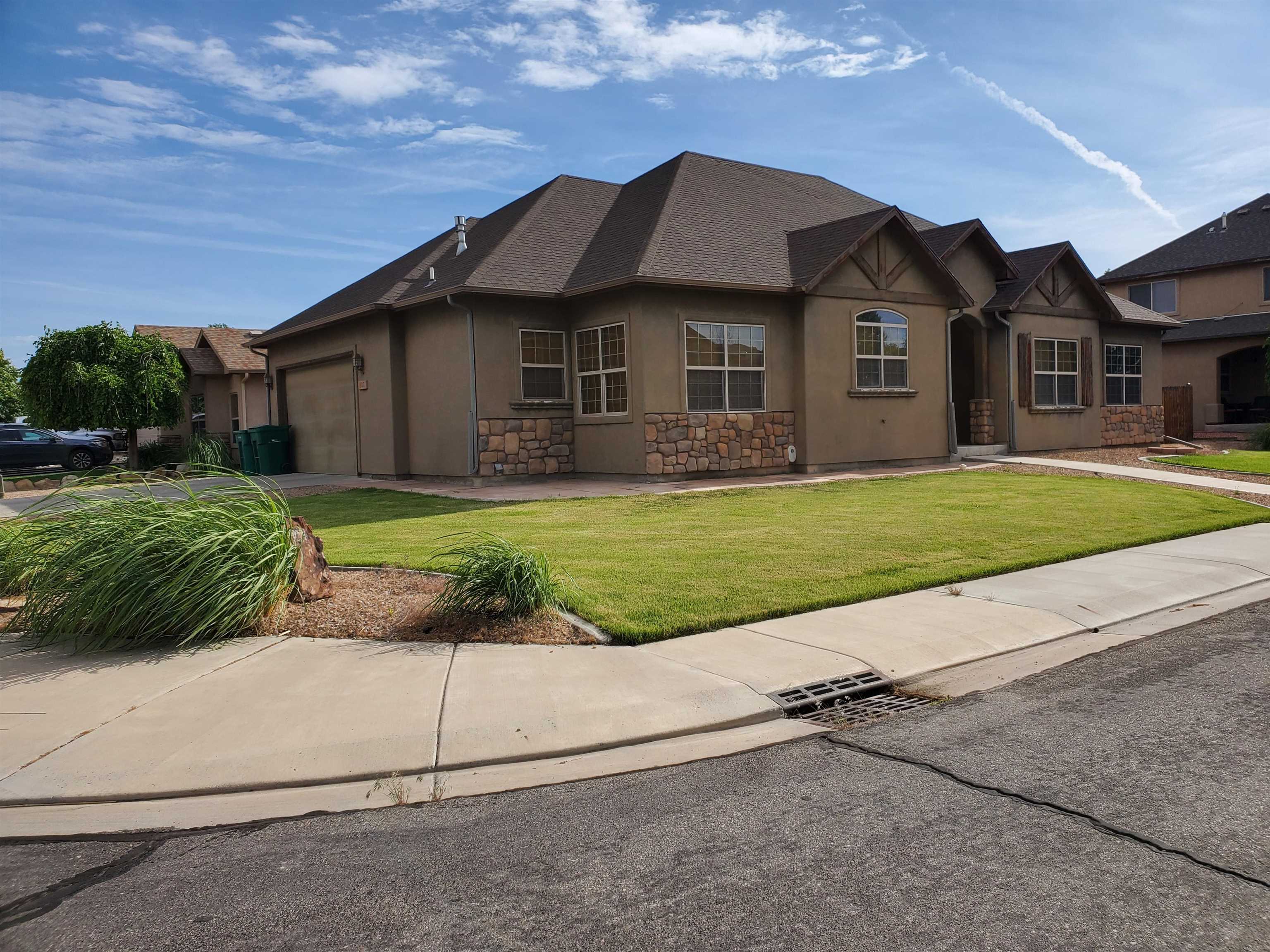 800 Esprit Lane Fruita, CO 81521 - Photo 37 of 38 a front view of a house with a yard and garage