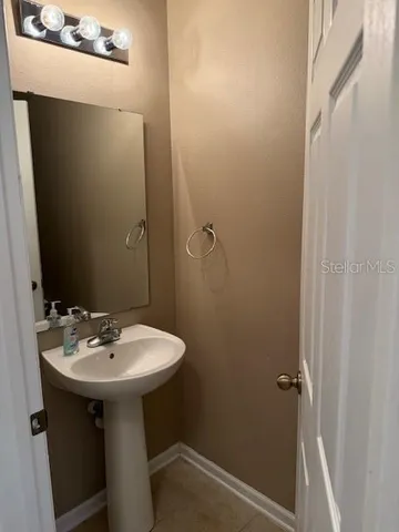 a bathroom with a sink a mirror and a toilet