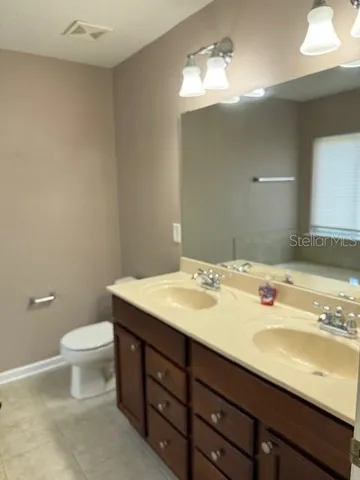 a bathroom with a sink toilet and a mirror