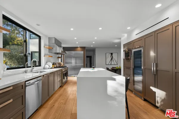 a large white kitchen with a large window