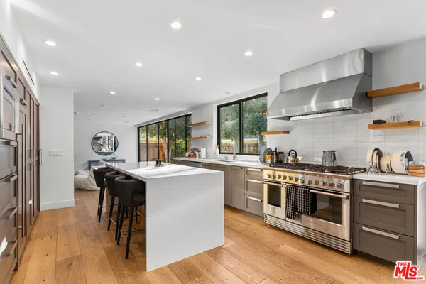 a kitchen with stainless steel appliances granite countertop a stove and a refrigerator