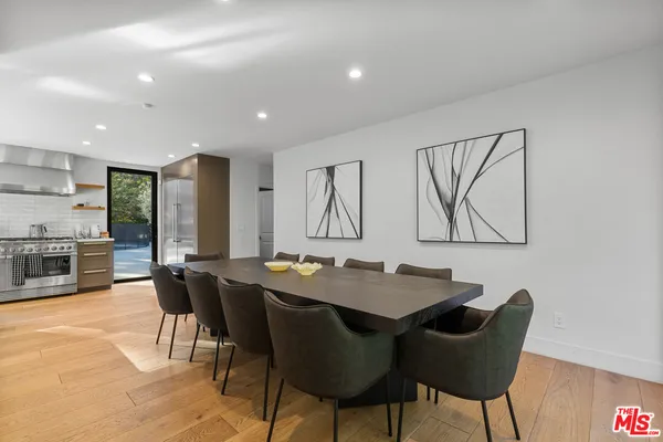 a view of a a dining room with furniture window and wooden floor