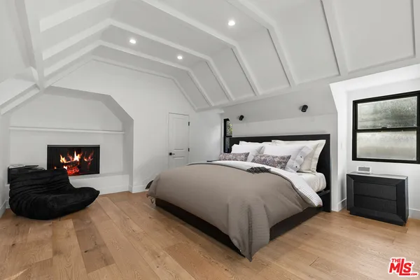 a bedroom with a bed and a fireplace
