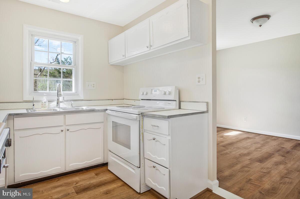 830 Joppa Farm Road Joppa, MD 21085 - Photo 15 of 41 a kitchen with granite countertop white cabinets and white appliances