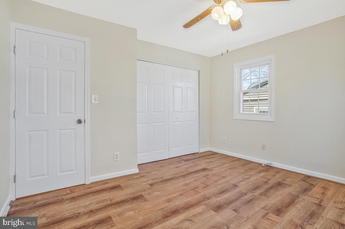 830 Joppa Farm Road Joppa, MD 21085 - Photo 20 of 41 an empty room with wooden floor and windows