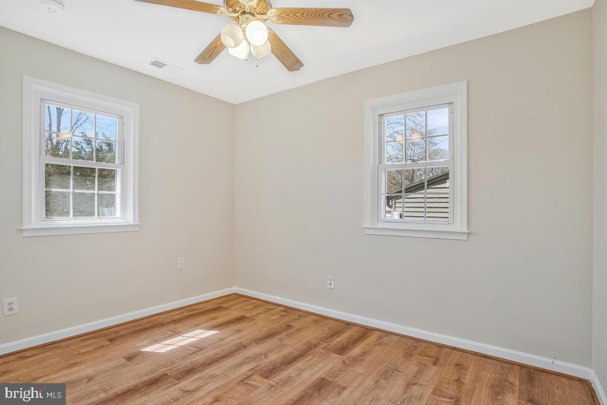 830 Joppa Farm Road Joppa, MD 21085 - Photo 23 of 41 a view of empty room with wooden floor and fan