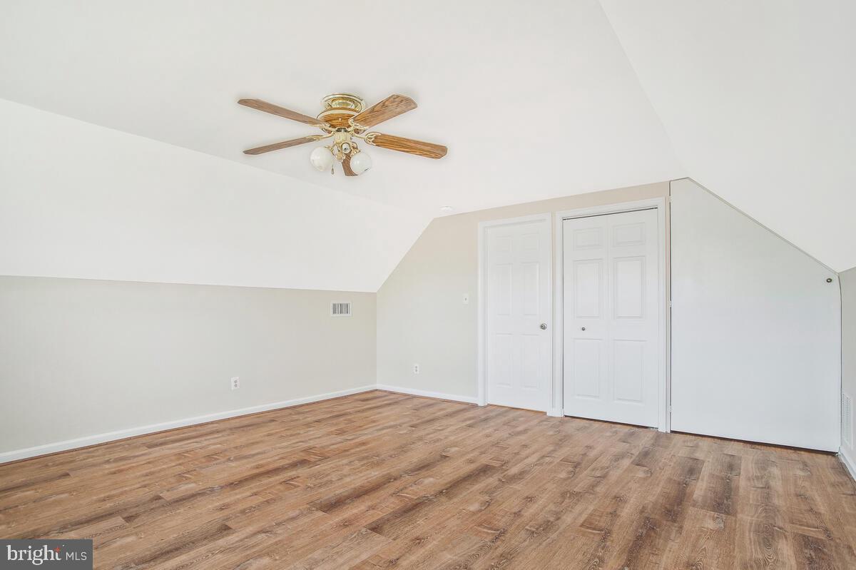 830 Joppa Farm Road Joppa, MD 21085 - Photo 29 of 41 a view of a room with wooden floor and a ceiling fan