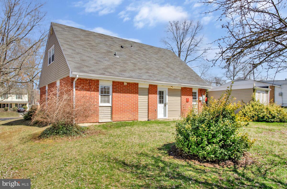 830 Joppa Farm Road Joppa, MD 21085 - Photo 4 of 41 a view of a house with brick walls and a yard with plants
