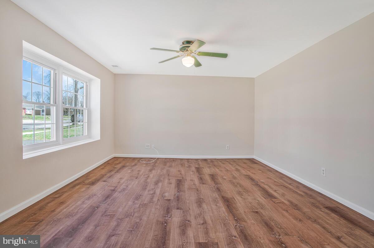 830 Joppa Farm Road Joppa, MD 21085 - Photo 6 of 41 a view of empty room with wooden floor and fan