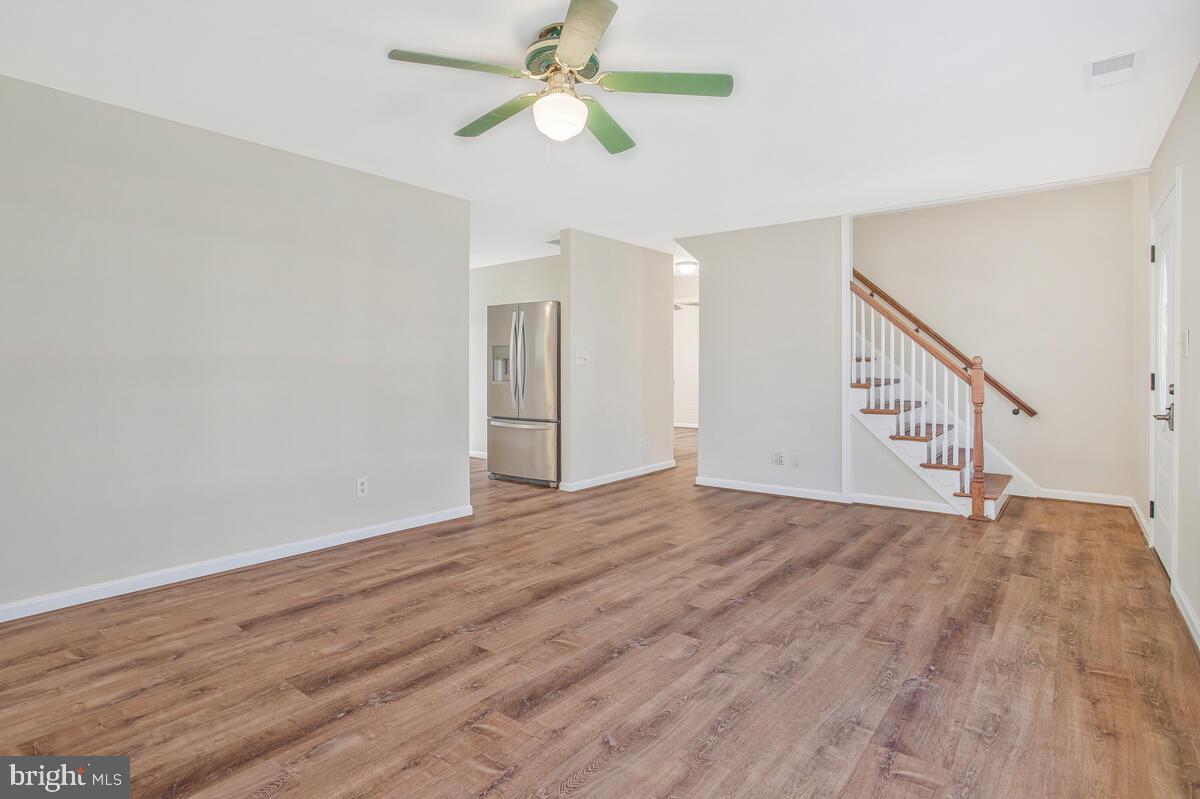 830 Joppa Farm Road Joppa, MD 21085 - Photo 8 of 41 a view of empty room with wooden floor and fan