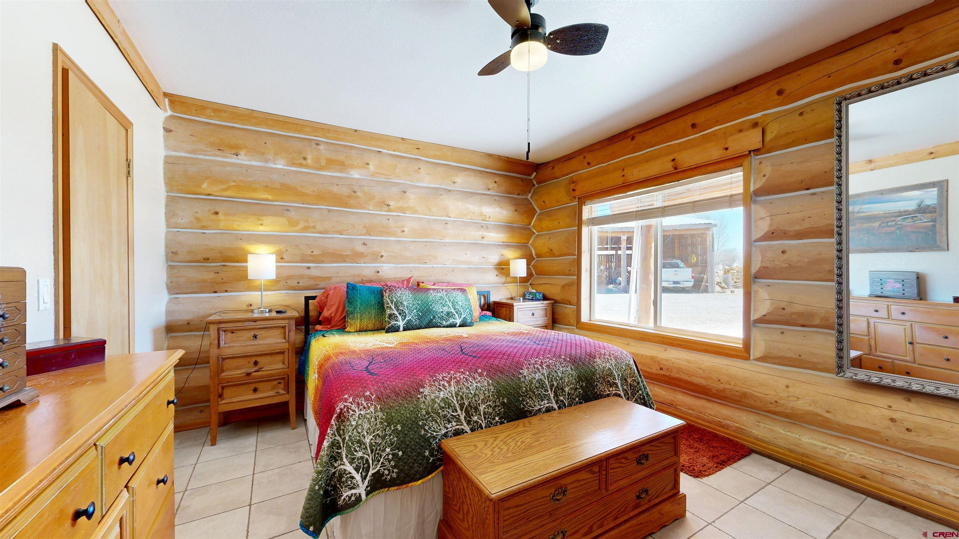 2083 Pioneer Road Delta, CO 81416 - Photo 26 of 45 a bedroom with a bed and large windows