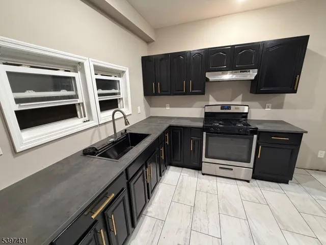 a kitchen with stainless steel appliances a stove and a microwave