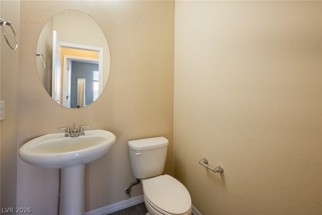 11016 Prairie Grove Road Las Vegas, NV 89179 - Photo 31 of 37 A well-appointed half bath features a pedestal sink and simple, clean finishes.