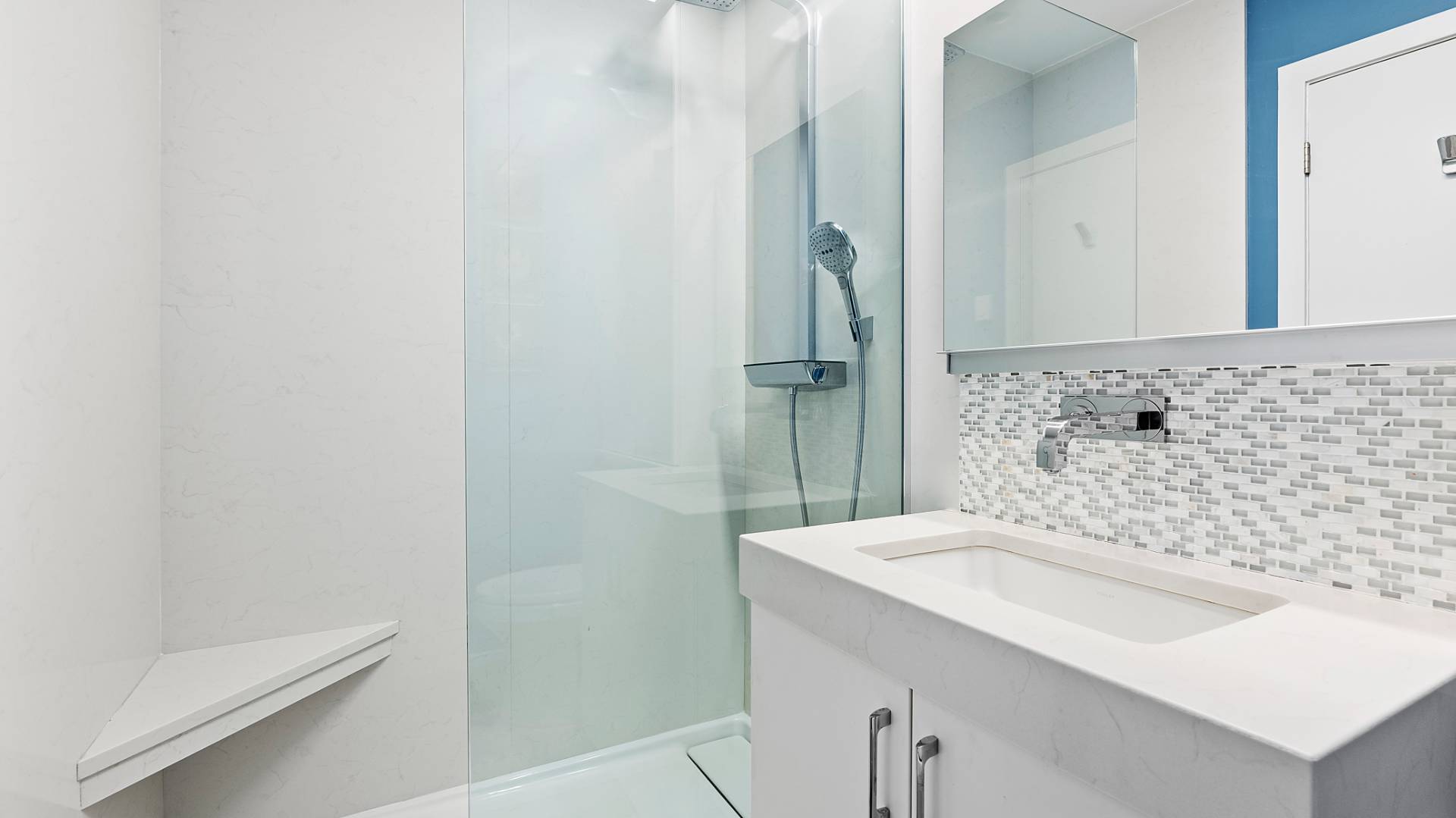 18 Bridge Street, Unit 4D Sag Harbor, NY 11963 - Photo 13 of 16 a bathroom with a sink and a mirror