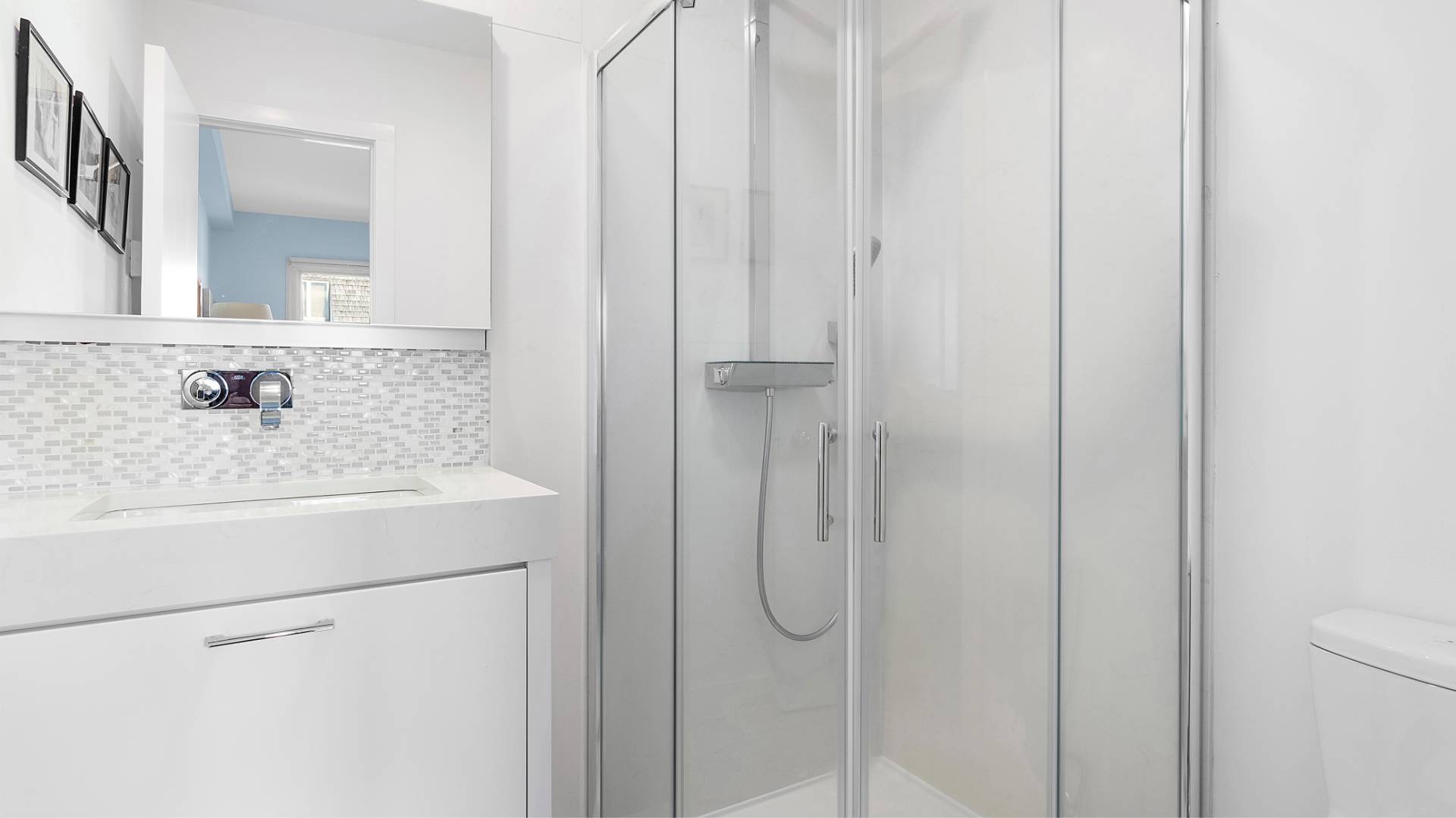 18 Bridge Street, Unit 4D Sag Harbor, NY 11963 - Photo 15 of 16 a bathroom with a granite countertop sink and a mirror