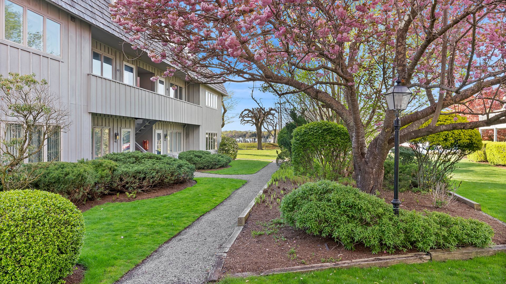 18 Bridge Street, Unit 4D Sag Harbor, NY 11963 - Photo 4 of 16 a front view of a house with garden