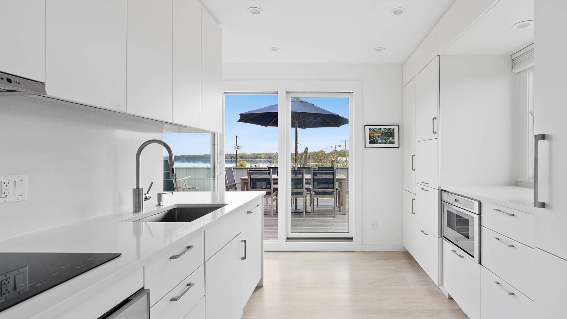 18 Bridge Street, Unit 4D Sag Harbor, NY 11963 - Photo 7 of 16 a kitchen with white cabinets and sink