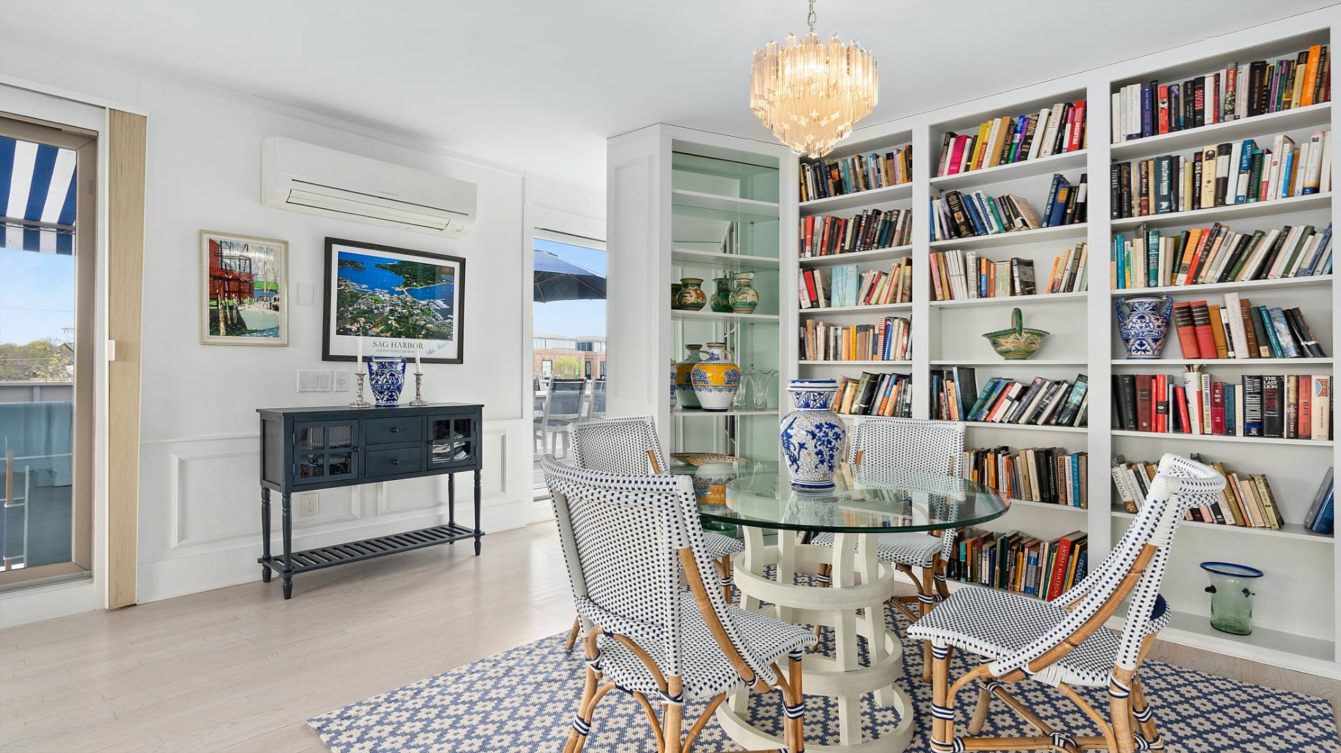 18 Bridge Street, Unit 4D Sag Harbor, NY 11963 - Photo 8 of 16 a dining room with furniture and a book shelf