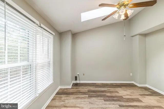 a view of a livingroom with an empty space and a window