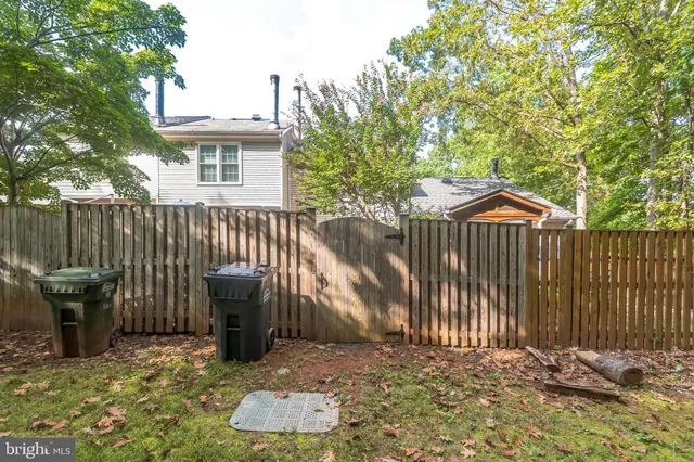 a backyard of a house with barbeque oven and outdoor seating