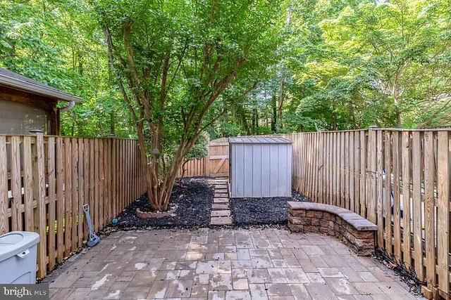 a view of a pathway with a wrought fence