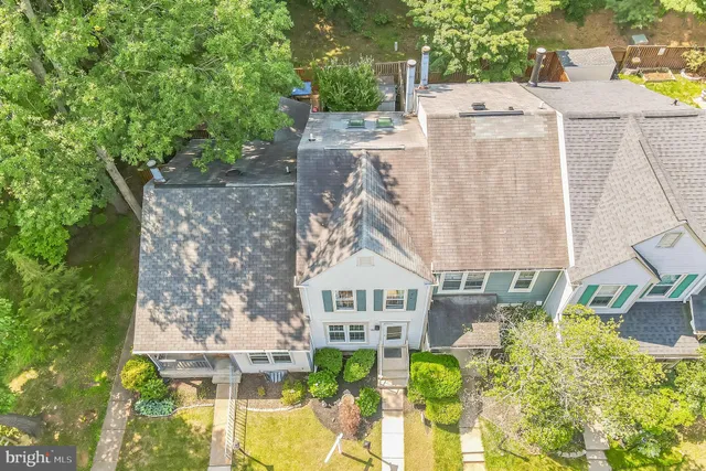 an aerial view of residential house with outdoor space and trees around