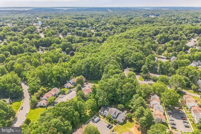 an aerial view of a houses with a yard