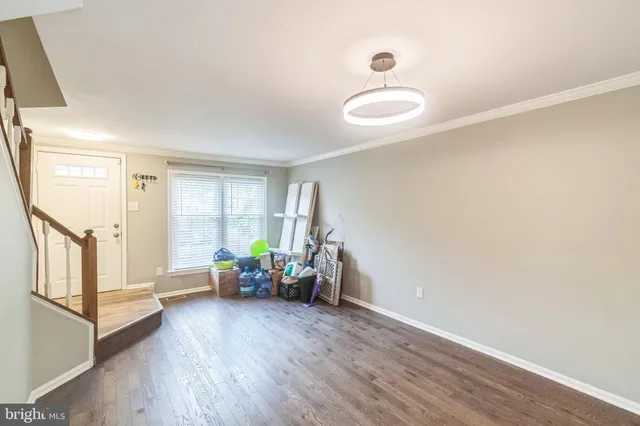 a view of a livingroom with furniture and hardwood floor