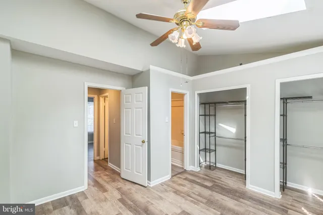 a view of a livingroom with a ceiling fan and entryway