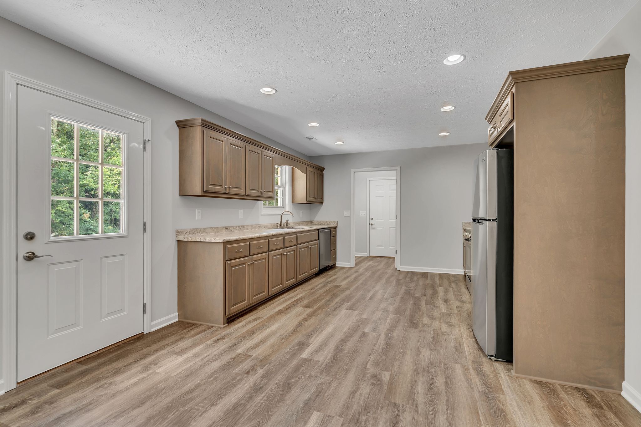 393 Flowertown Road Normandy, TN 37360 - Photo 13 of 34 a view of a kitchen with wooden floor and electronic appliances