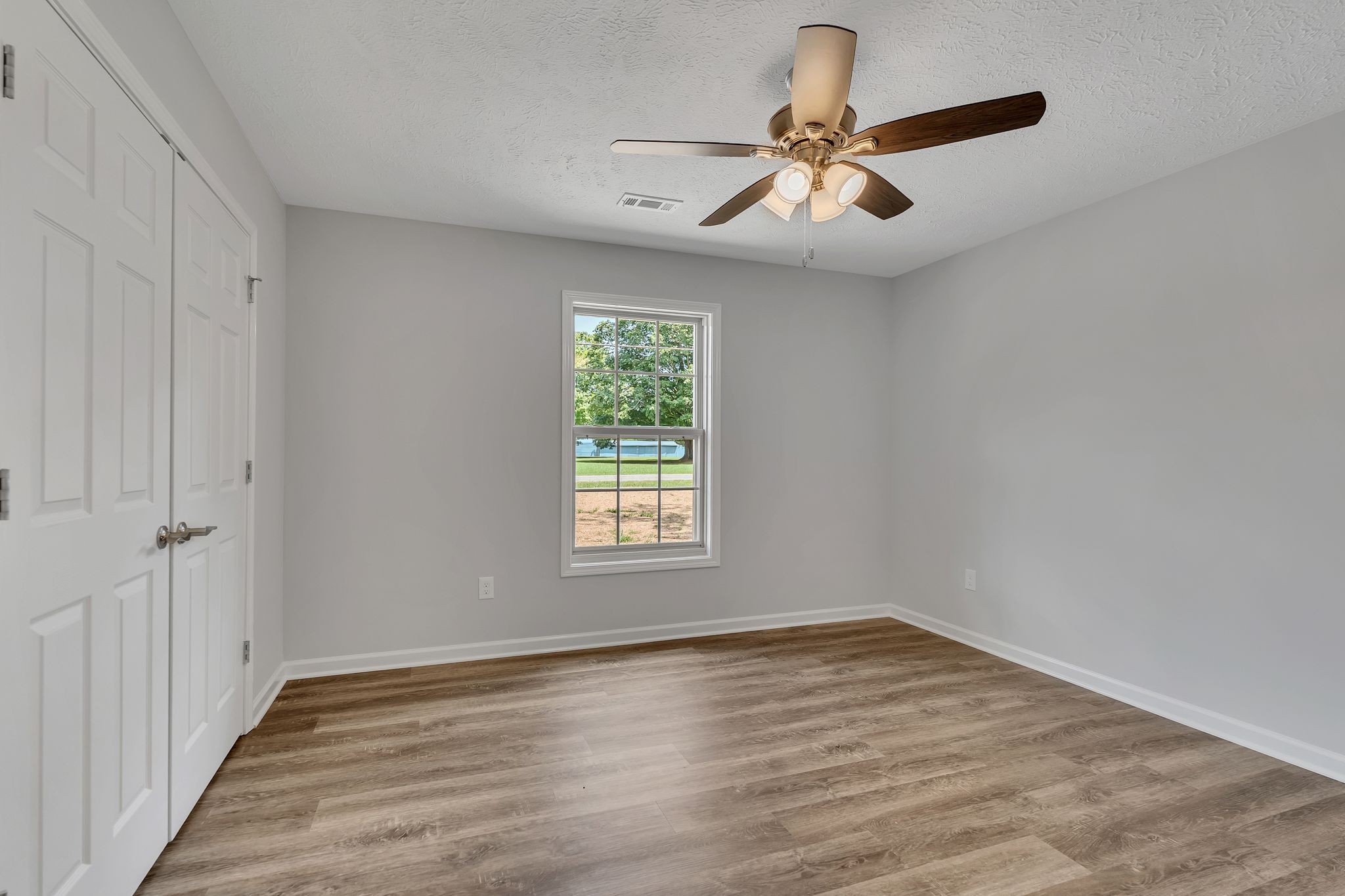 393 Flowertown Road Normandy, TN 37360 - Photo 24 of 34 a view of empty room with wooden floor and fan