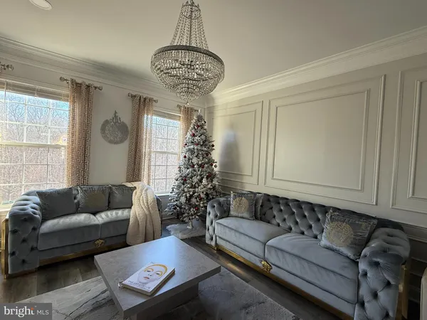 a living room with furniture and a chandelier