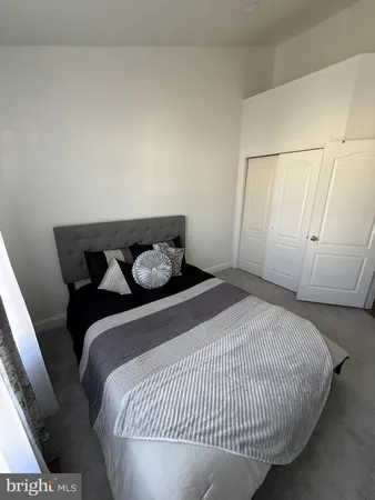 a bedroom with a bed and white wall
