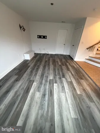 a view of a room with wooden floor