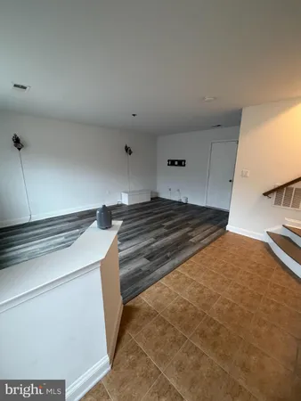 a kitchen with a stove and white cabinets