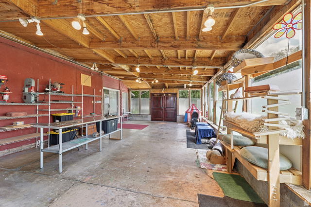 365 North Main Street Fillmore, UT 84631 - Photo 29 of 51 Spacious enclosed sunroom with exposed wood ceiling beams, concrete flooring, and an expansive window wall