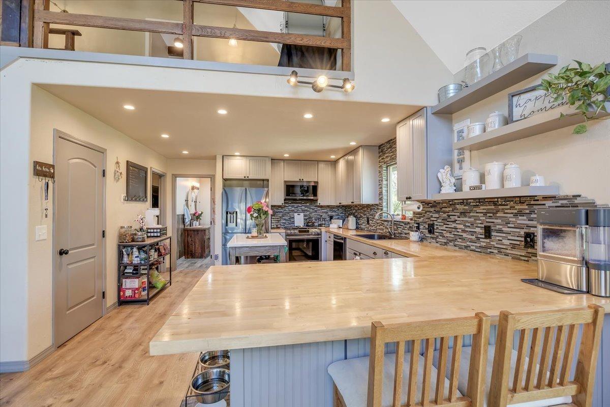 1499 Sawmill Road, Unit 594 Copperopolis, CA 95228 - Photo 24 of 98 Floating shelves and glass-tiled backsplash add appeal.